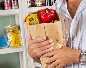 Image showing Man Holding Bag Of Vegetables In Store