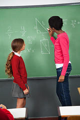 Image showing Female Teacher Teaching Mathematics To Teenage Schoolgirl