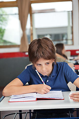 Image showing Schoolboy Cheating At Desk During Examination