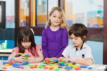 Image showing Girl With Friends Playing Blocks In Kindergarten