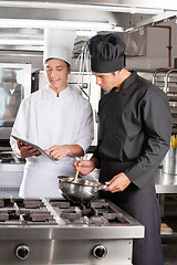 Image showing Young Chefs With Digital Tablet Preparing Food