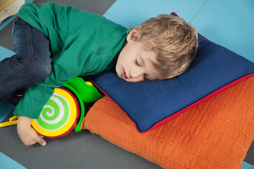 Image showing Boy sleeping With Toy In Kindergarten