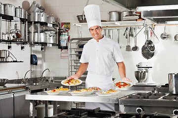 Image showing Confident Chef Presenting Pasta Dishes
