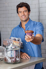 Image showing Mid Adult Man Holding Cupcake At Supermarket