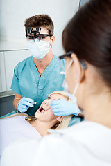 Image showing Dentist And Female Assistant Treating A Patient At Clinic