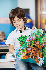 Image showing Boy With Popup Book Sitting On Desk In Kindergarten