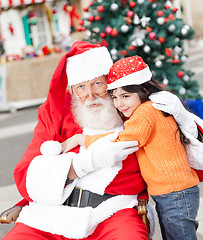 Image showing Santa Claus Embracing Girl