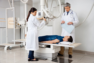 Image showing Radiologists With Patient In X-ray Room