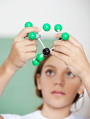 Image showing Teenage Schoolgirl Examining Molecular Structure