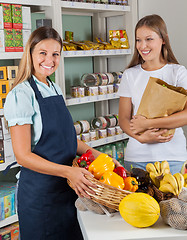 Image showing Saleswoman Holding Vegetable Basket