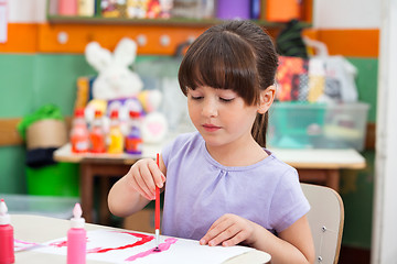 Image showing Girl Painting At Desk In Classroom