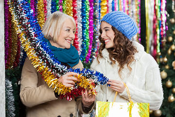 Image showing Mother And Daughter Shopping For Tinsels