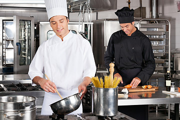 Image showing Happy Chefs Preparing Food