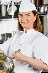 Image showing Chef Mixing Egg With Wire Whisk In Bowl