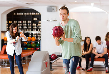 Image showing Man Bowling With Friend Photographing in Club