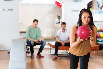 Image showing Young Woman Holding Bowling Ball in Club