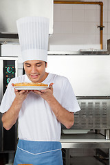 Image showing Chef Smelling Sweet Dish In Kitchen