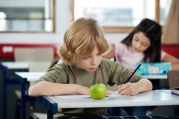 Image showing Schoolboy Writing In Book