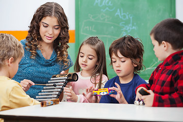 Image showing Teacher Teaching Students To Play Xylophone In Class
