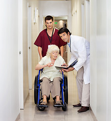 Image showing Medical Professionals With Patient In Corridor