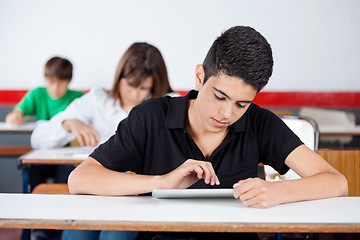 Image showing Teenage University Student Using Digital Tablet At Desk