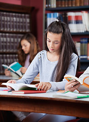 Image showing Teenage Schoolgirl Studying In Library