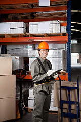 Image showing Supervisor Writing On Clipboard At Warehouse