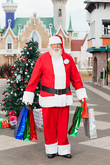 Image showing Santa Claus Carrying Shopping Bags In Courtyard