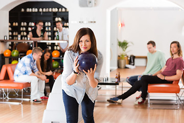 Image showing Young Woman Bowling in Club