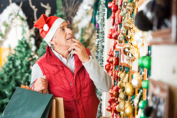 Image showing Man Selecting Christmas Ornaments