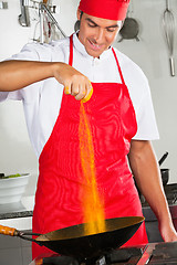 Image showing Chef Adding Turmeric Powder In Pan