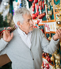 Image showing Man Buying Christmas Ornaments At Store