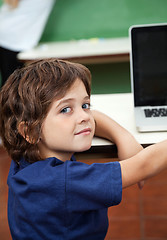 Image showing Boy With Laptop On Desk In Classroom