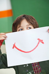 Image showing Boy Holding Paper With Smile Drawn On It