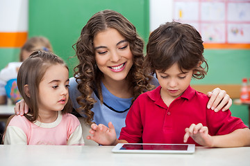 Image showing Children Using Digital Tablet With Teacher