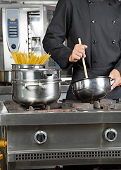 Image showing Male Chef Preparing Spaghetti