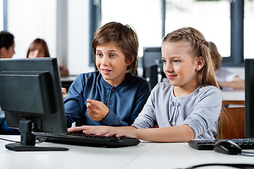 Image showing Boy Pointing While Using Desktop Pc With Friend At Desk