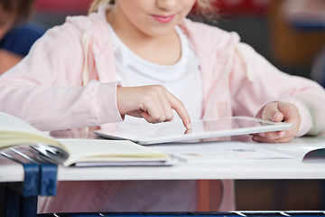 Image showing Midsection Of Schoolgirl Using Tablet At Desk