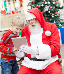 Image showing Boy And Santa Claus Using Digital Tablet