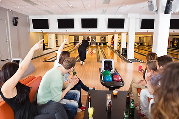 Image showing Friends Cheering Woman Bowling in Club