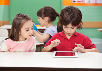 Image showing Boy Using Digital Tablet With Friend At Desk