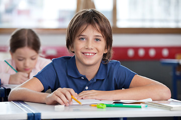 Image showing Cute Schoolboy Smiling In Classroom