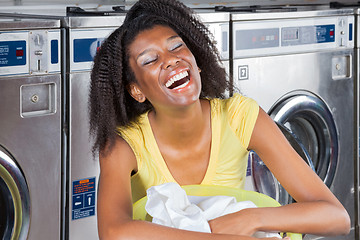 Image showing Young Woman With Clothes Basket At Laundromat