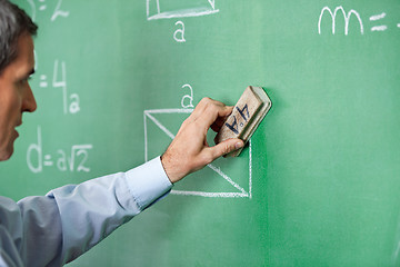 Image showing Male Professor Cleaning Greenboard With Duster