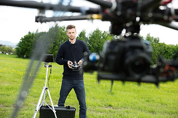 Image showing Engineer Flying  UAV Helicopter in Park