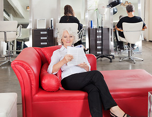 Image showing Woman Reading Magazine With Clients Waiting For Hairdresser