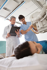 Image showing Technician Setting Up Machine To X-ray Patient