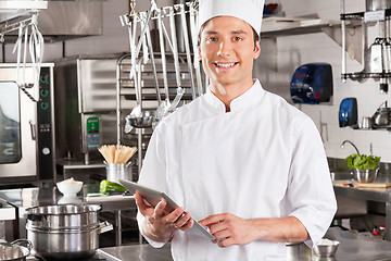 Image showing Happy Chef Holding Tablet Computer