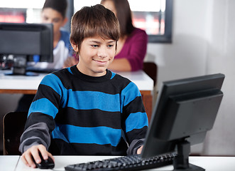 Image showing Boy Smiling While Using Computer In Classroom