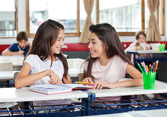 Image showing Schoolgirls Looking At Each Other In Classroom